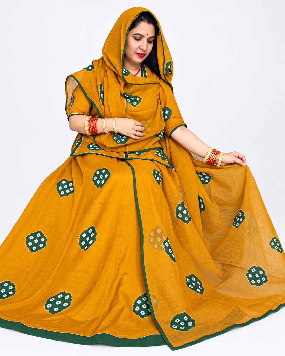 Beautiful mustard yellow Sentoon hand-dyed suit featuring traditional Ladu Bandhej design, green border detailing and matching cotton odhni by Panavi Paridhan.