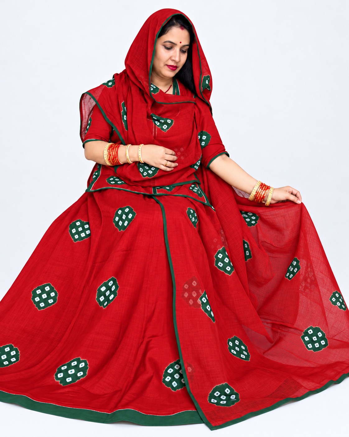 Red Sentoon hand dai suit with traditional ladu bandhej design, light green motifs, matching cotton odhni, and green border detailing, displayed in a studio-style product photo.